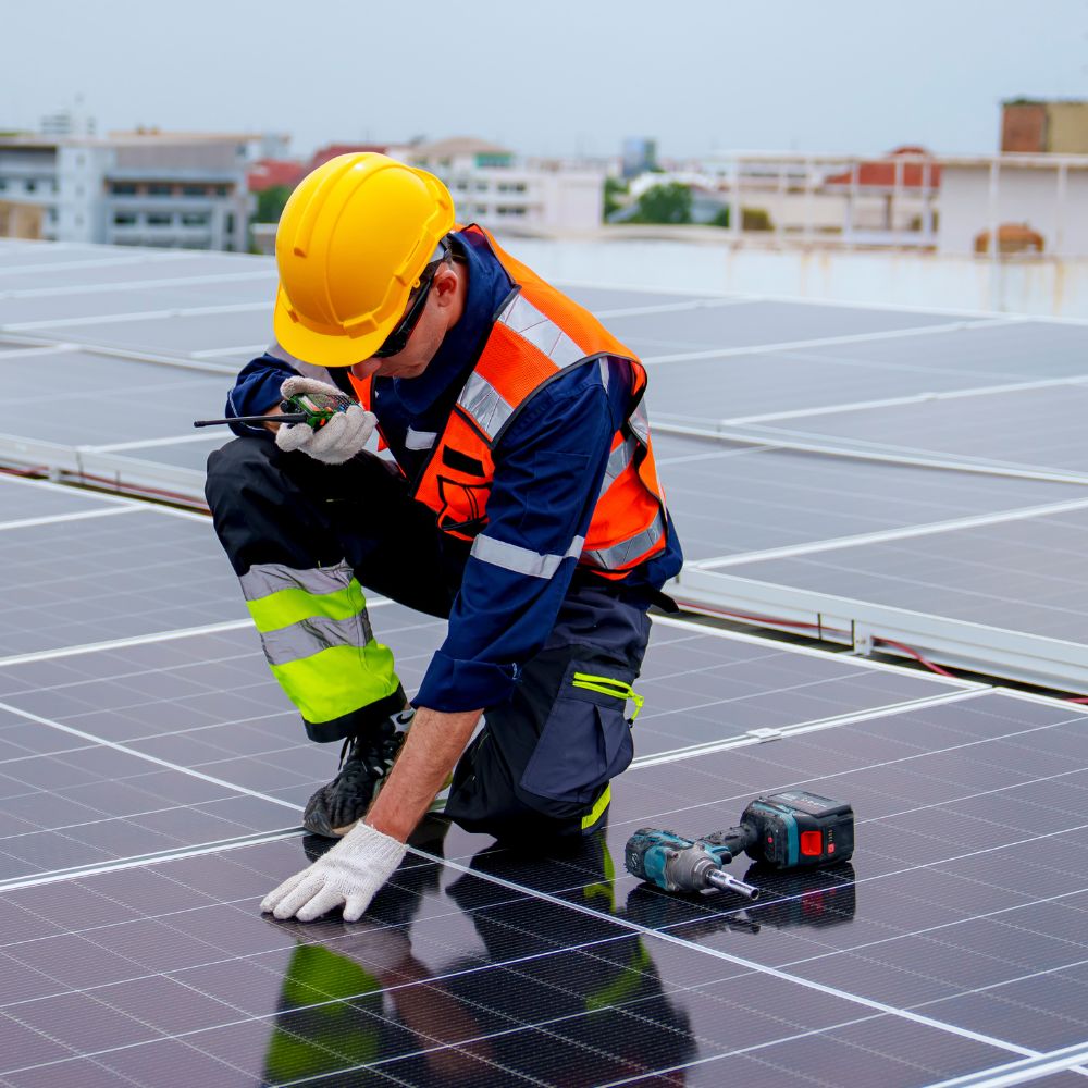 Man inspecting solar panels representing solar panel maintenance service by PJB Cleaning Services Ltd