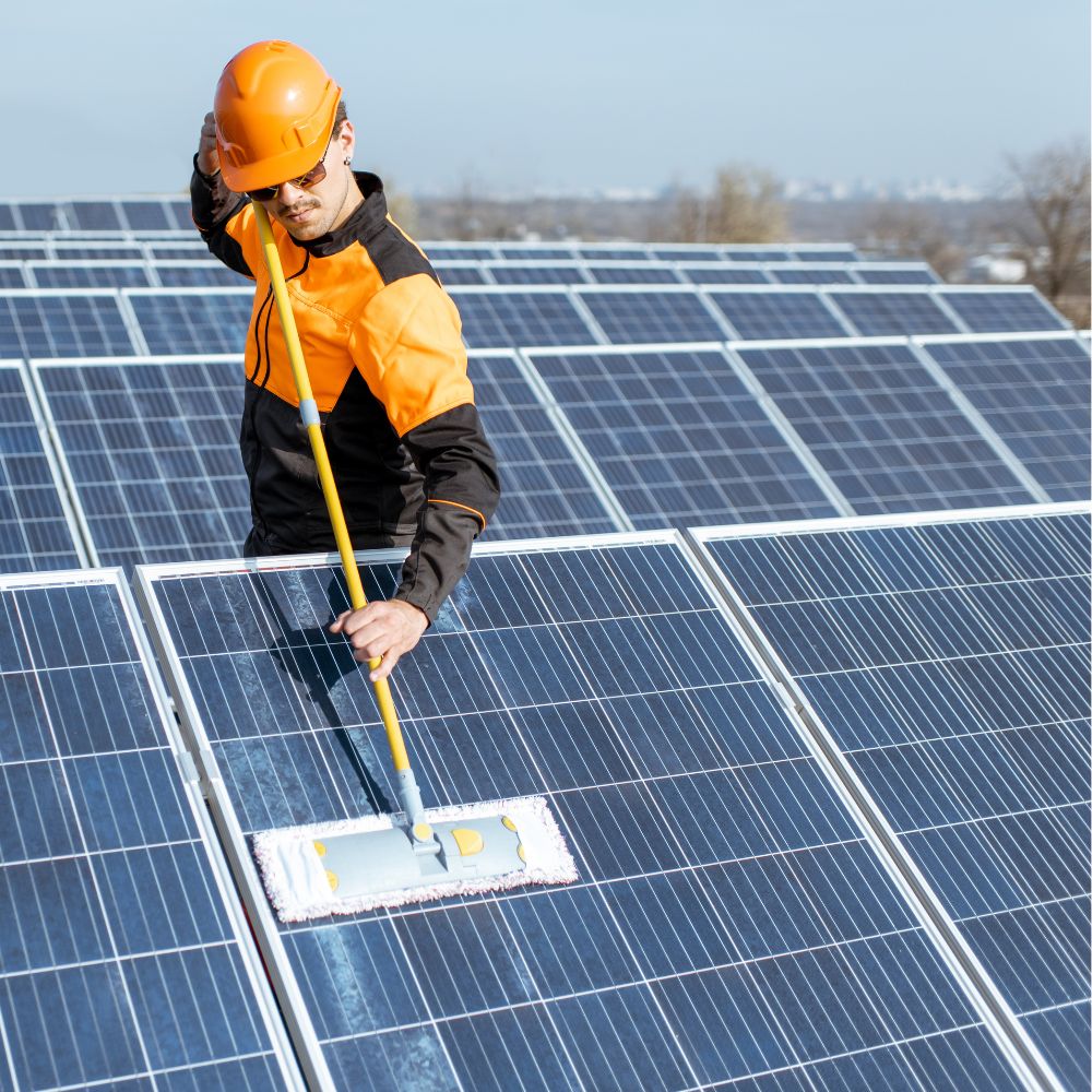Technician cleaning residential solar panels using specialist solar panel cleaning equipment